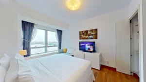Bedroom with queen size bed and city view in serviced apartment