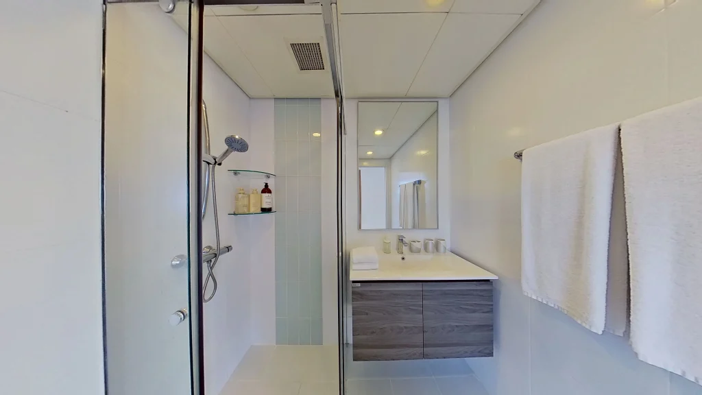 Modern bathroom with sink, cabinet, and towel.