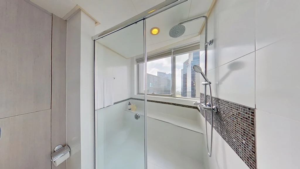 Modern apartment bathroom with composite tile flooring.