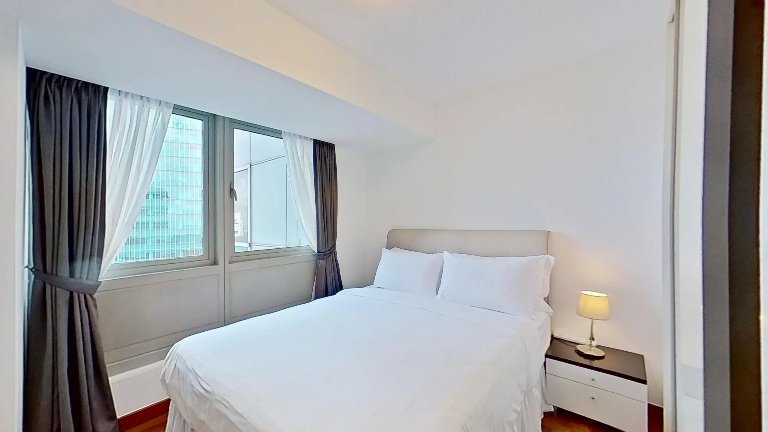 Modern bedroom with bed and nightstand.