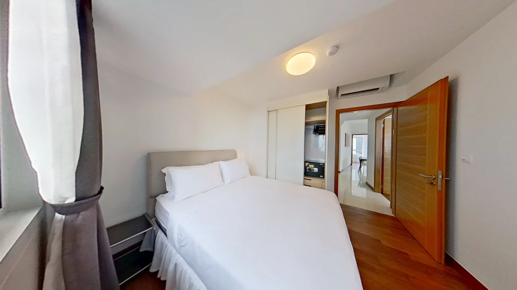 Modern bedroom with bed, door, and pillow.
