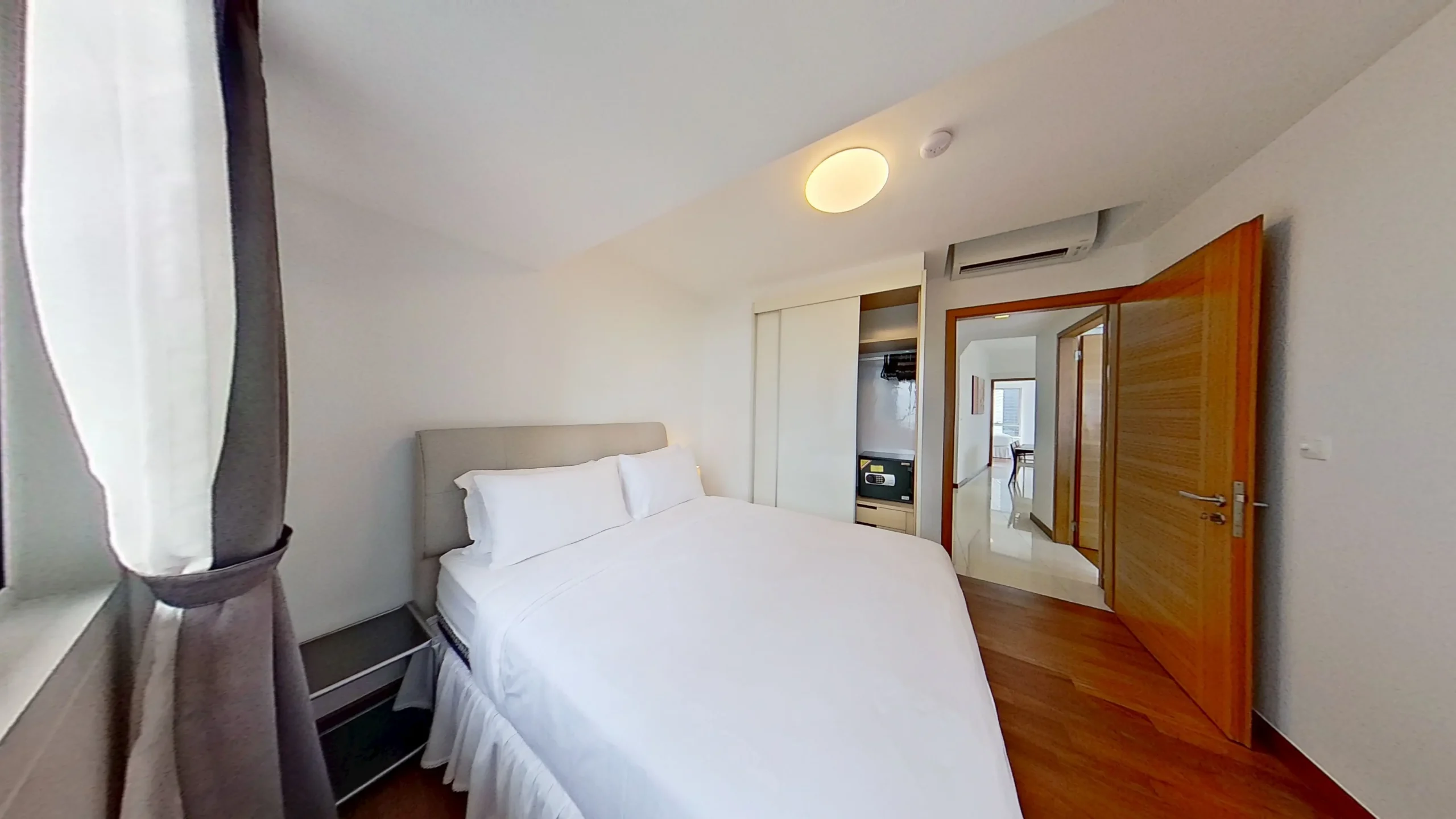 Modern bedroom with bed, door, and pillow.