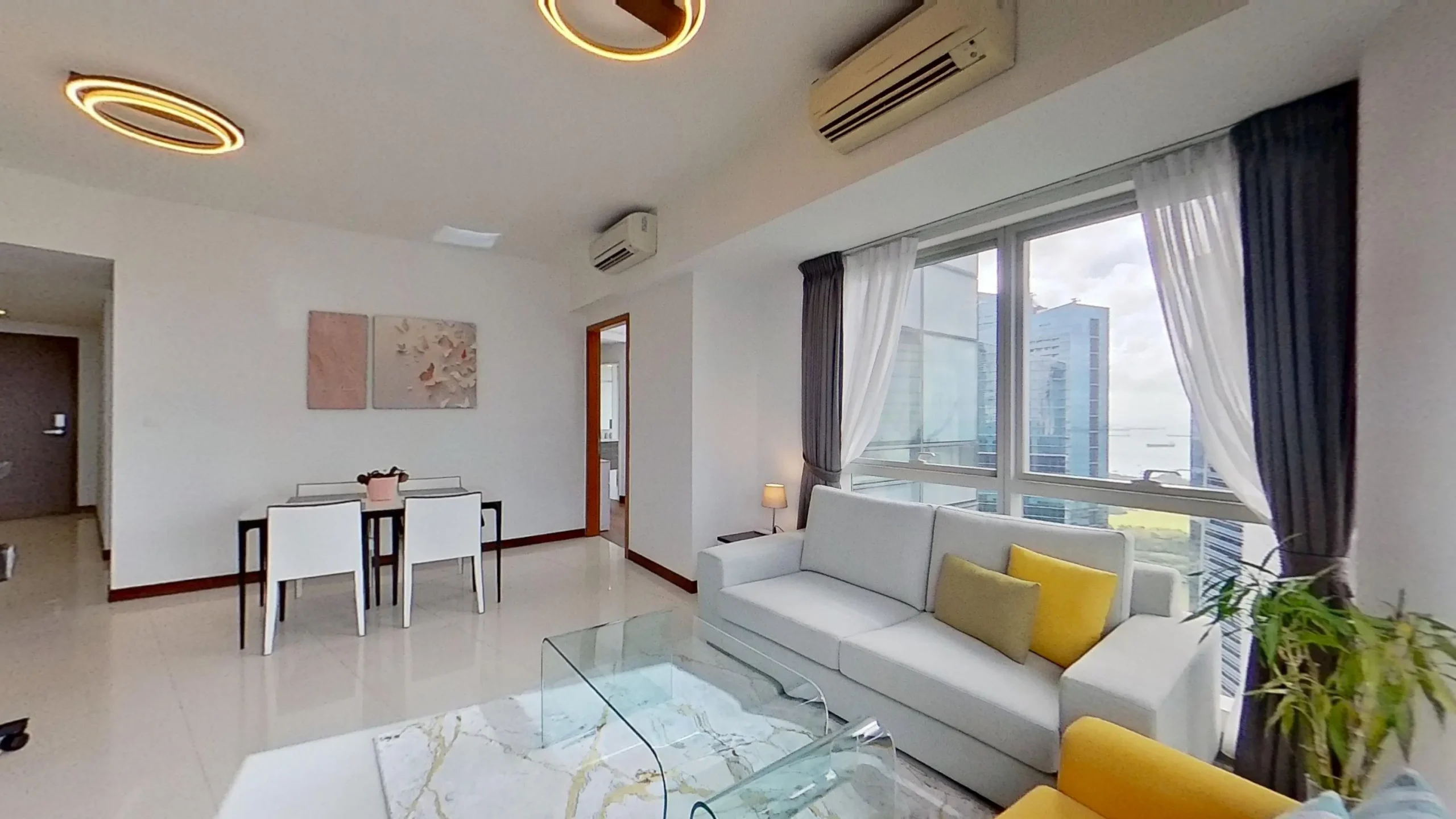Modern living room with couch, chair, houseplant.