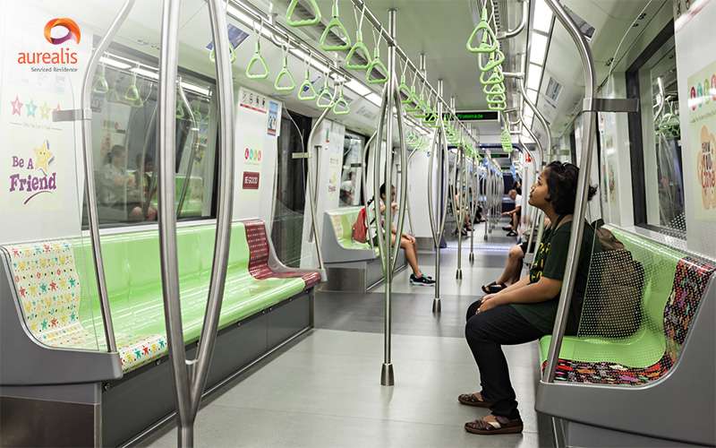 Expat sitting in MRT on their daily commute in Singapore