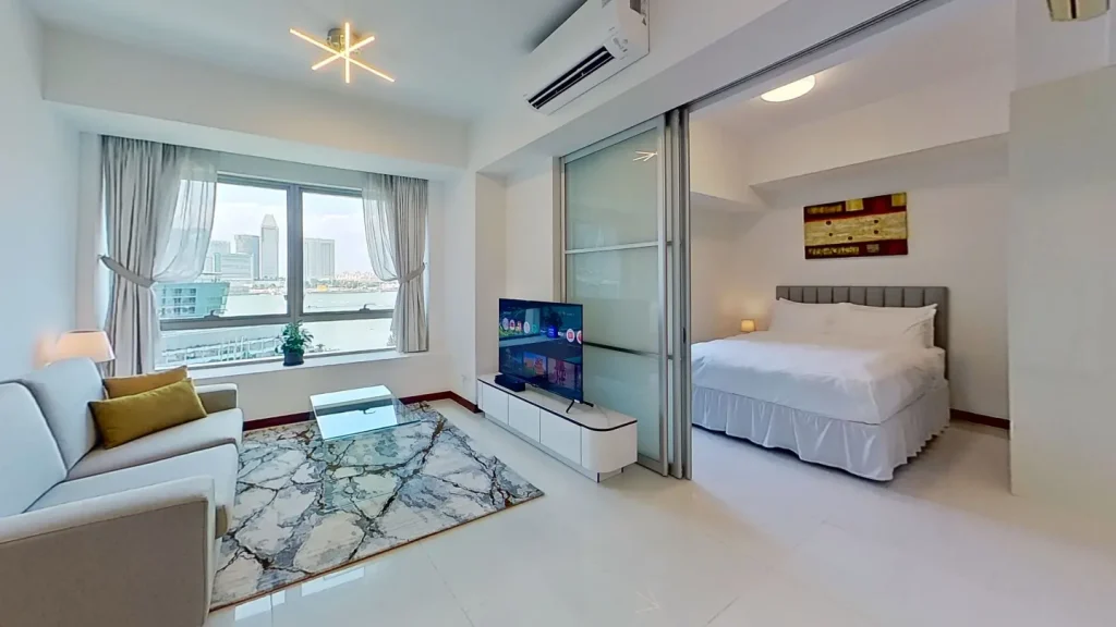 Two bedroom bayview suite living area link to bedroom at Marina Bay