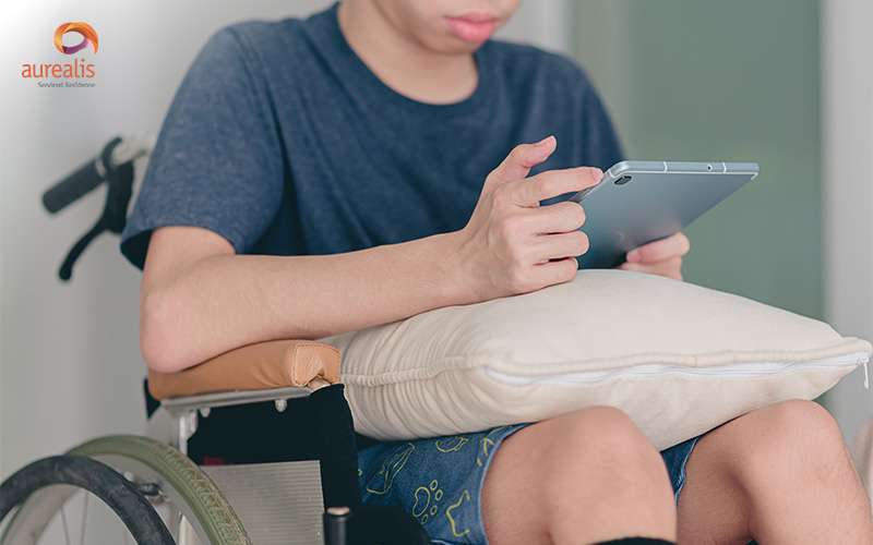 Person in a wheelchair using an iPad