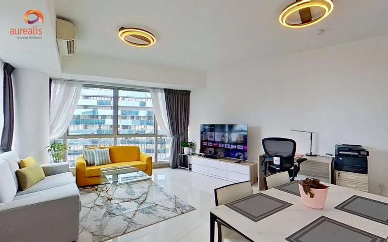 Modern serviced residence with yellow couch, desk setup, and dining area.