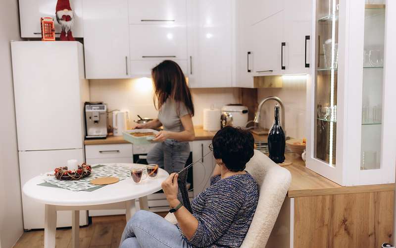 Residents utilizing kitchen facilities in a Singapore serviced apartment.