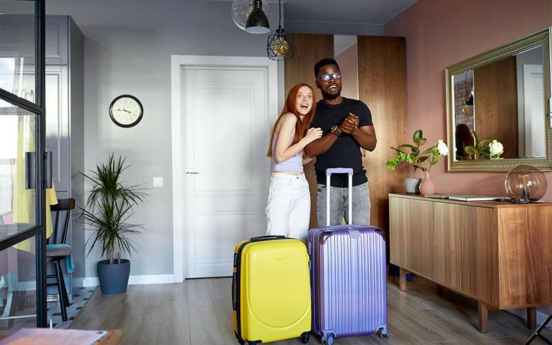 Couple arriving at a modern serviced apartment.