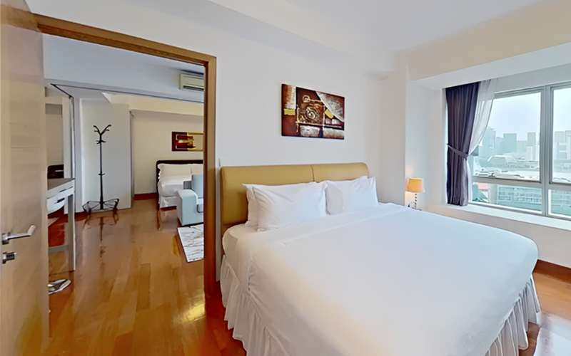 Modern two bedroom serviced apartment layout with a city view.