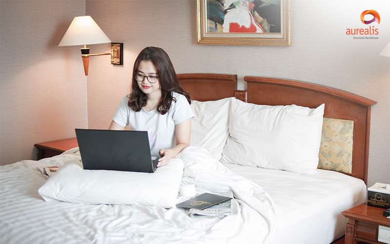 Guest working on laptop in Aurealis Serviced Residence.